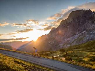 Riding a road bike in the Haslital Valley at sunset.
