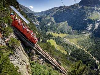 Le train de Gelmer avec ses passagers et son conducteur, offrant une belle vue par temps ensoleillé.