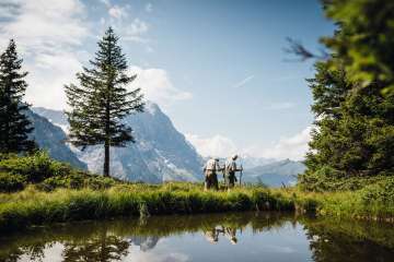 Hiking along a pond. The Eiger can be seen in the distance.