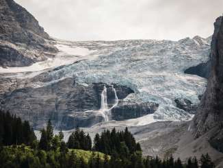 Der imposante Rosenlaui Gletscher bei Schattenhalb. Unterhalb des Gletschers ist ein Wasserfall zu sehen.