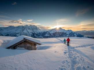At sunset—and against a stunning mountain backdrop: Two snowshoers out and about on the Hasliberg