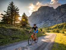Riding a road bike in the Haslital Valley at sunset.